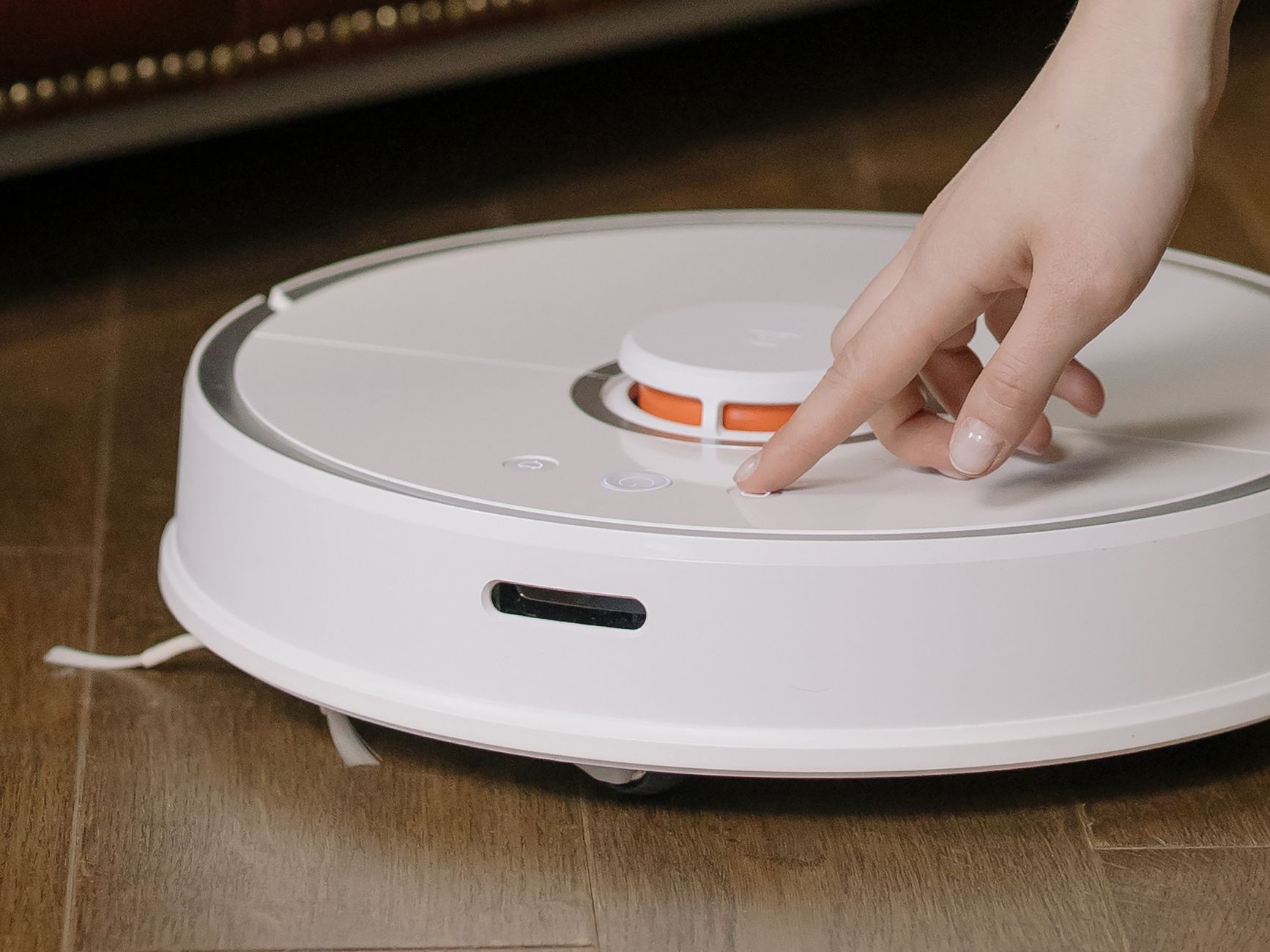 AI modern vacuum cleaner scanning obstacles on tile floors
